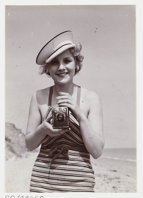 Woman taking a photograph, about 1935