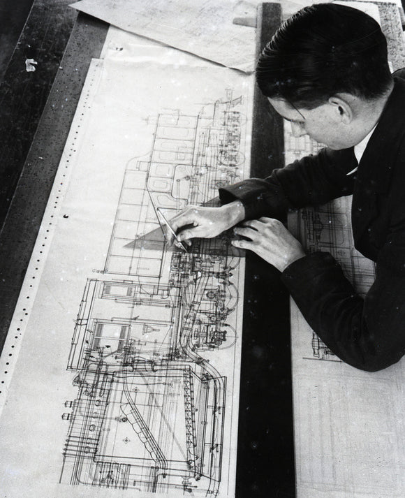 Draughtsman Brian Pearson, an employee in the Drawing Office, working on drawing for War Department. 1945.