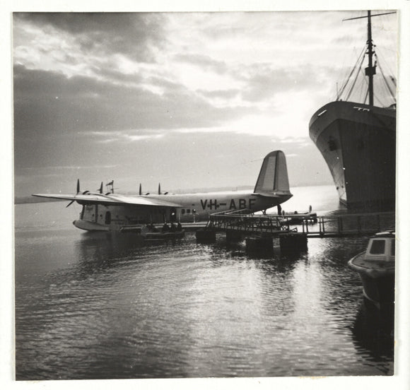 Flying boat moored at a jetty, c 1935.