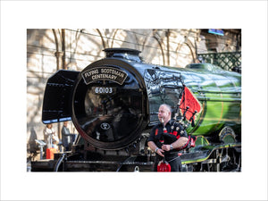 Kevin MacDonald from the Red Hot Chilli Pipers beside Flying Scotsman.
