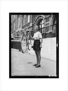 Woman holding a lightweight bicycle, 1934.