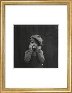 Boy playing the harmonica, about 1925