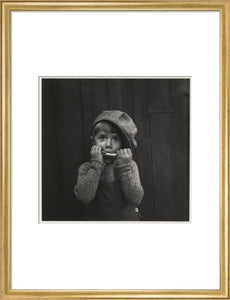 Boy playing the harmonica, about 1925