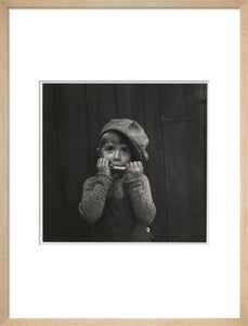Boy playing the harmonica, about 1925