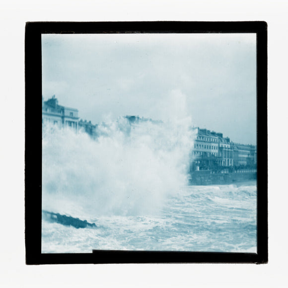 A magic lantern slide of sea waves crashing against the shore by Birt Acres, c. 1893.
