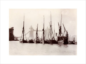 Boats moored at Tower Bridge, 1890s.