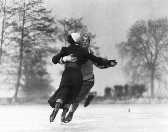 Couple skating on an ice rink, c 1930s.