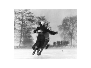 Couple skating on an ice rink, c 1930s.