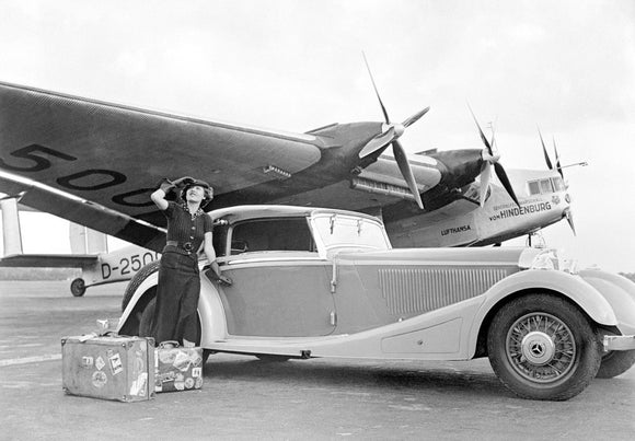 Woman standing alongside a Mercedes-Benz motor car, 1935.