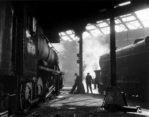 Grimy 8F and Class 5 steam locomotives in a