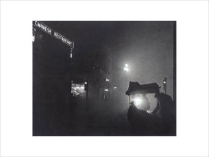 'A foggy Piccadilly partially lit by the light from a fruit seller's stall', 1952.