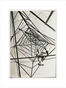 Man climbing a pylon, c 1930.