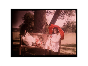Girl with a parasol sitting on a bench, 1908.