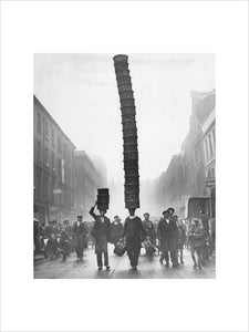 Covent Garden porter carrying a basket 'Eiffel Tower', 1928.