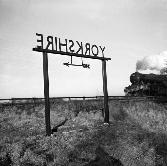 Train approaching a 'Yorkshire' sign on the boundary with County Durham, 1951.