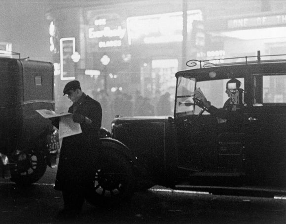 Taxis queueing in traffic during bad fog in central London, 1934. Photograph by James Jarche (1891-1965).