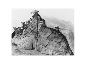 British soldiers looking out from their improvised tent, 1914-1918.