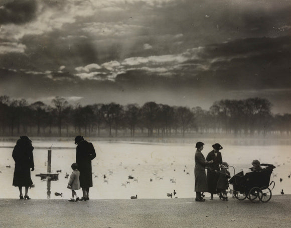 Walkers enjoying the sunset across the Serpentine in Hyde Park, 1938
