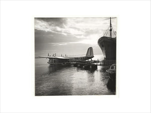 Flying boat moored at a jetty, c 1935.