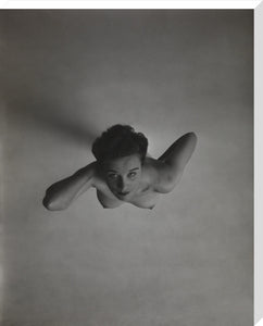 Standing naked woman looking up to camera