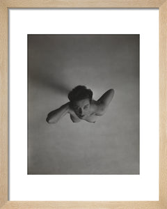Standing naked woman looking up to camera