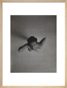 Standing naked woman looking up to camera