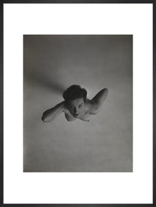 Standing naked woman looking up to camera