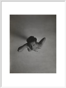 Standing naked woman looking up to camera