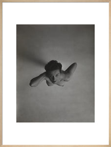 Standing naked woman looking up to camera