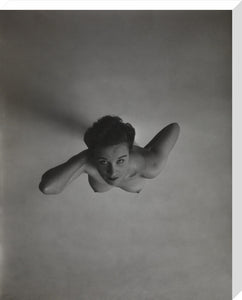 Standing naked woman looking up to camera