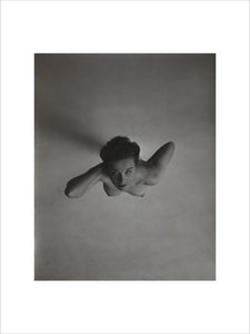 Standing naked woman looking up to camera
