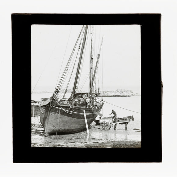 A magic lantern slide of a boat in harbour by Birt Acres, c. 1893.