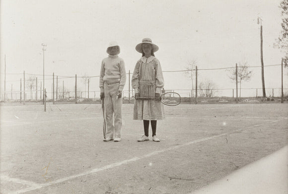 H. H. Prince Nikita Alexandrovitch and Atia Staroselsky on the tennis court, both are holding rackets.
